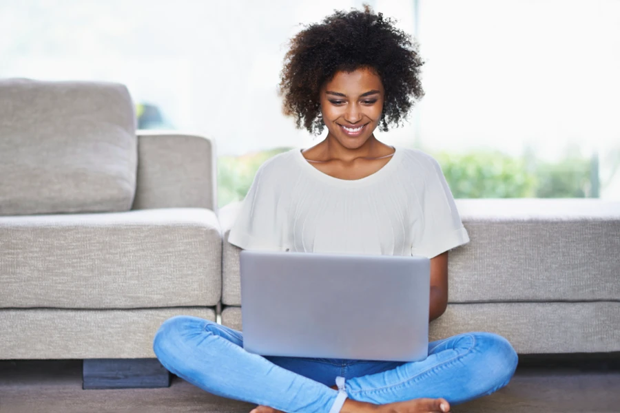 Young person looking at dental plans on her laptop.