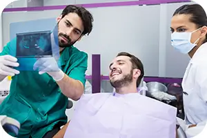 Dentist showing his patient his X-rays.