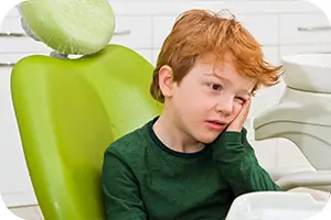 Young boy in dentist chair, he's not happy.